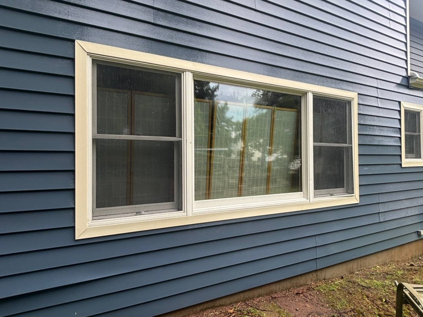 The same wall after washing — deep even blue and clean white trim