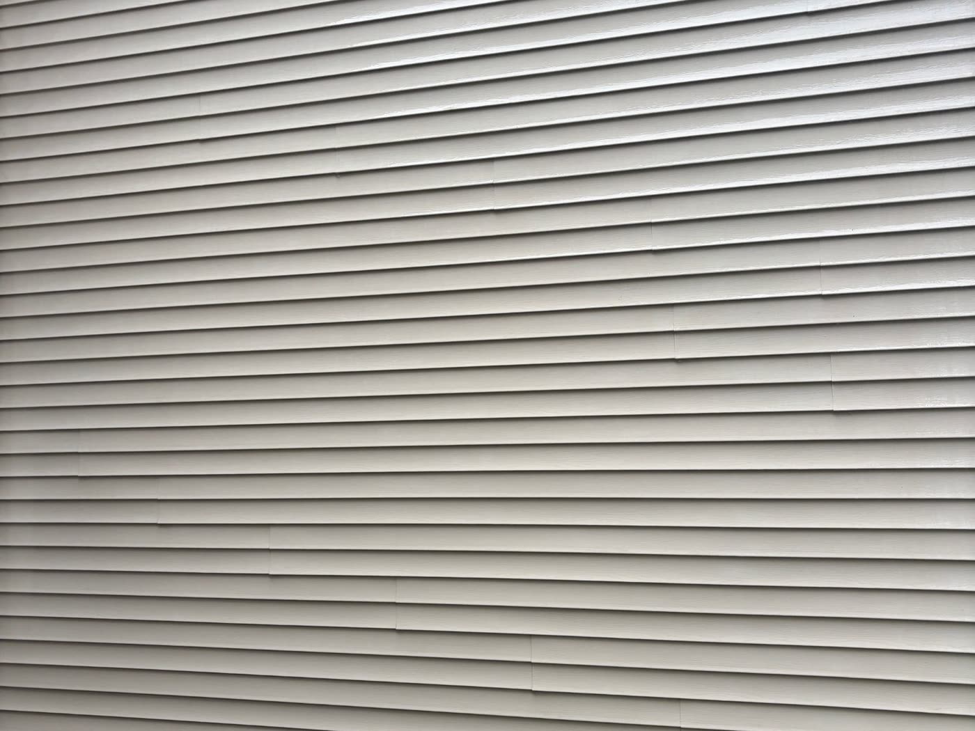 The same siding after a soft wash — clean and algae free