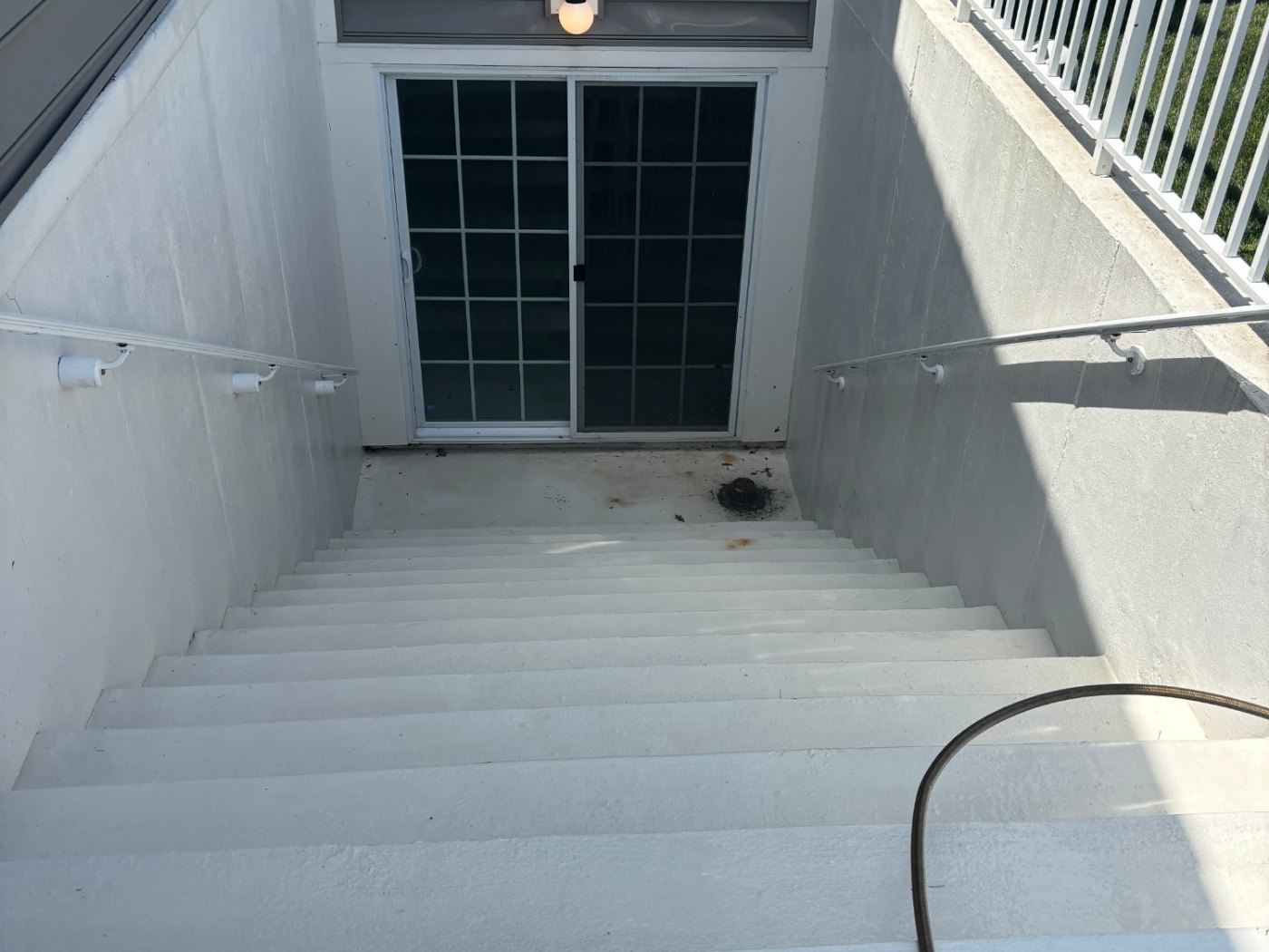 The same stairwell after washing — clean, pale concrete